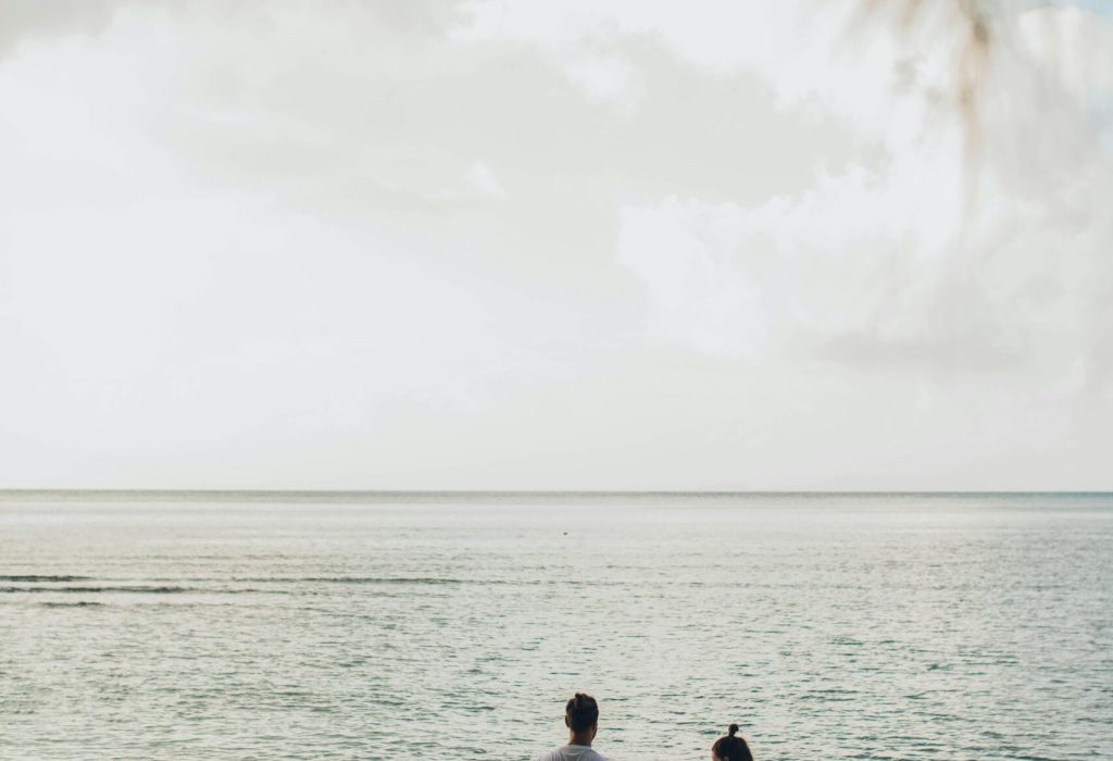 A family enjoys a tranquil day at the beach, highlighting togetherness and love.